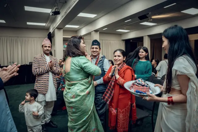 Guests in dhaka topi greeting each other with namaste